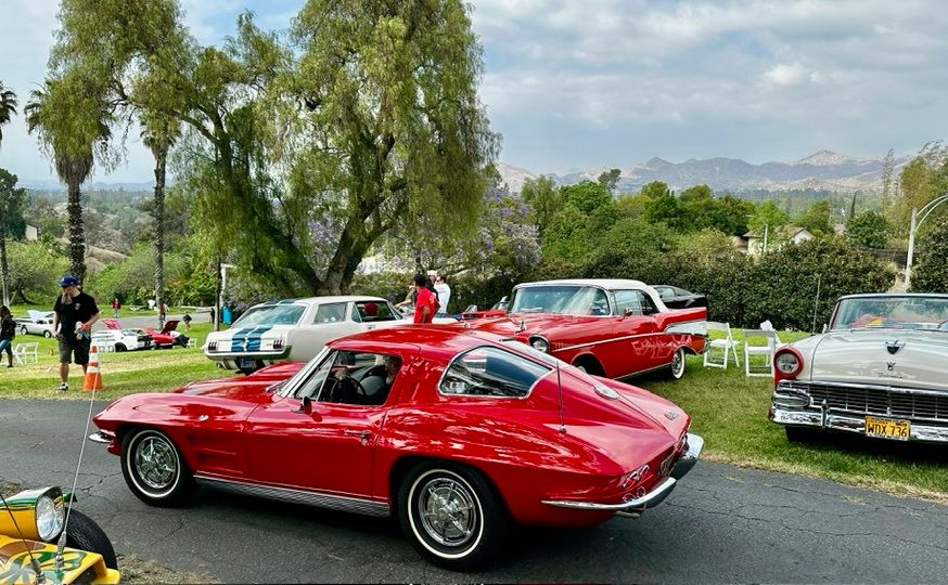 Red Chevrolet Corvette at Huntington Beach Car Club event